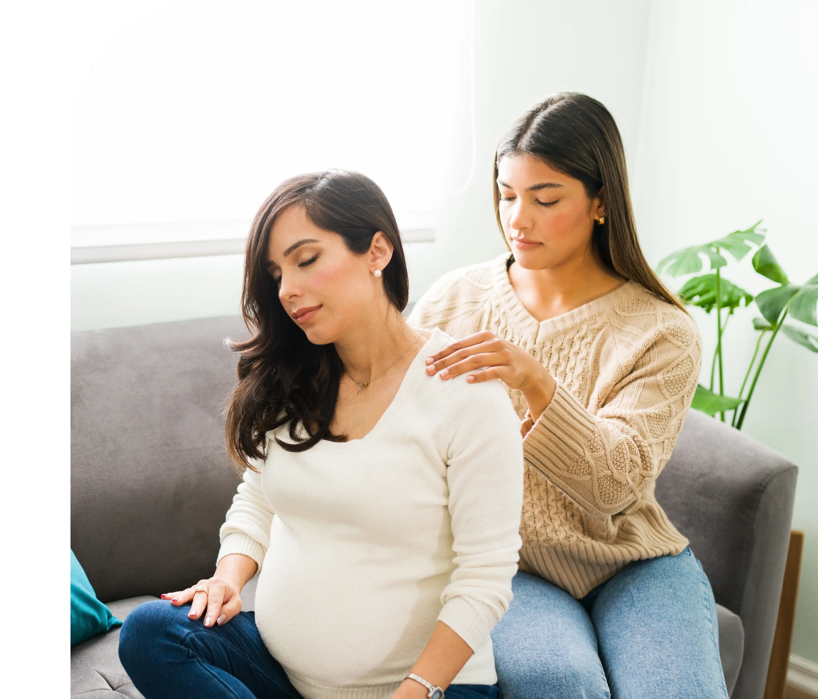 Pregnant woman receiving a shoulder massage.